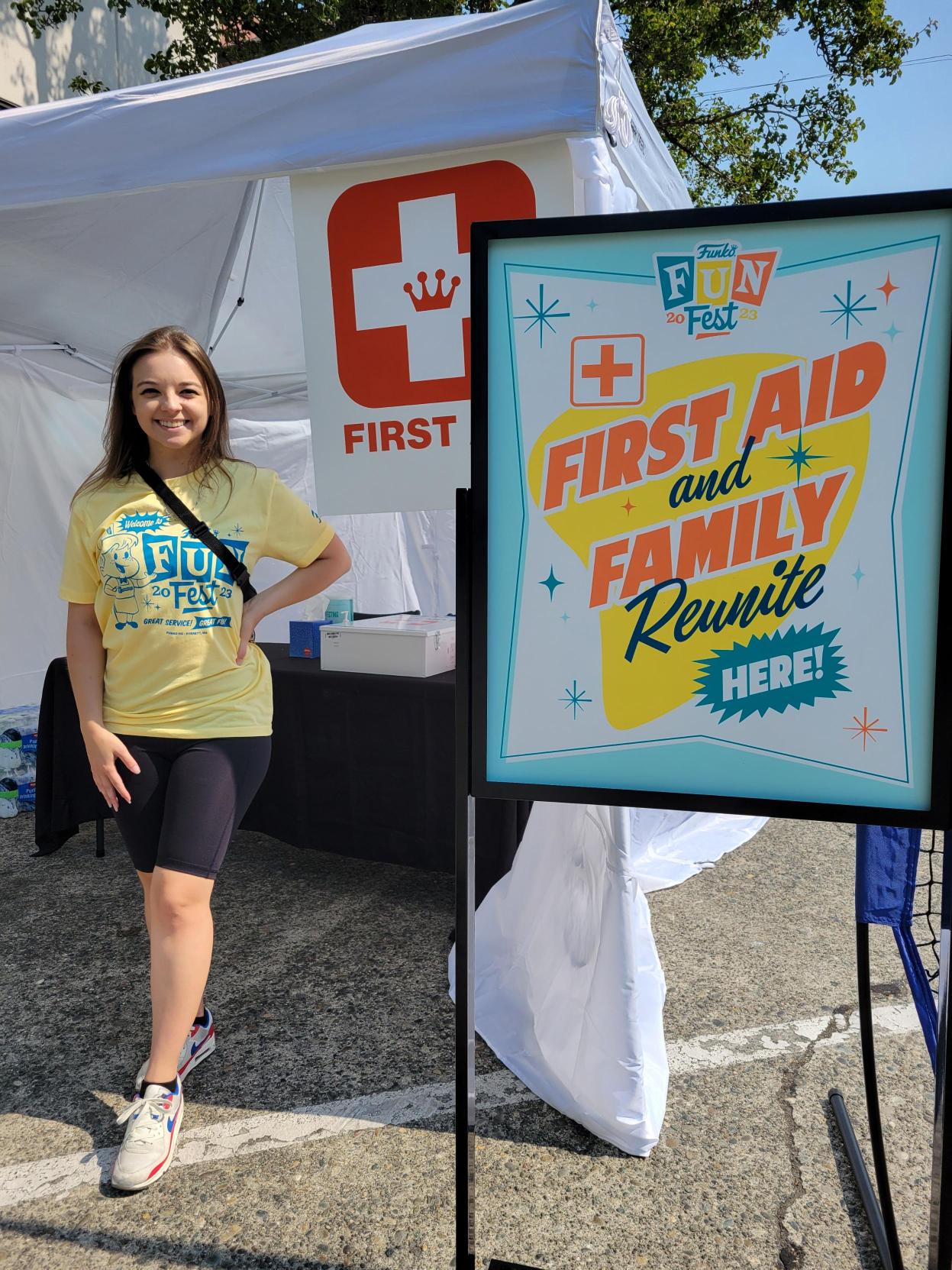 First-Aid Tent: A Funko volunteer, in a yellow Fun Fest 2023 tee shirt staffs the First-Aid station.